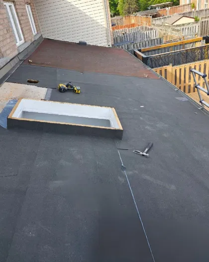 Flat roof skylight installation with waterproofing details